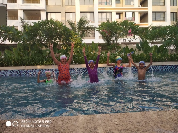 Kids enjoying the swimming pool at Raj Housing apartments in Goa